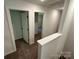 Upstairs hallway with neutral carpet and two doorways leading to bedrooms at 1563 Riverview Cir, Fort Lawn, SC 29714