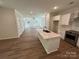 Open-concept kitchen with a large island, stainless steel appliances, and access to the living room at 1563 Riverview Cir, Fort Lawn, SC 29714
