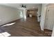 Open-concept living space featuring wood-look floors, ceiling fan, and access to the kitchen at 1563 Riverview Cir, Fort Lawn, SC 29714
