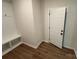 Bright mudroom with a built-in bench, storage cubbies, and stylish wood-look flooring at 1563 Riverview Cir, Fort Lawn, SC 29714