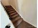 Carpeted staircase with dark handrail in a modern home at 1563 Riverview Cir, Fort Lawn, SC 29714