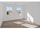 Bright bedroom with plush carpeting and abundant natural light from two windows at 15926 Parkside Crossing Dr # 322, Charlotte, NC 28273