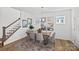 Bright dining area with a wooden table, gray chairs, modern mirrors, and a staircase at 15926 Parkside Crossing Dr # 322, Charlotte, NC 28273
