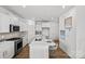 Open kitchen featuring white cabinets, quartz countertops, stainless steel appliances, and an island at 15926 Parkside Crossing Dr # 322, Charlotte, NC 28273
