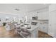 Spacious island with seating, white cabinets, stainless appliances in an open kitchen and living area at 15926 Parkside Crossing Dr # 322, Charlotte, NC 28273