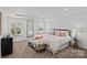 Spacious main bedroom with tray ceiling, large windows, and stylish decor at 15926 Parkside Crossing Dr # 322, Charlotte, NC 28273