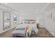 Comfortable main bedroom featuring tray ceiling, abundant natural light, and neutral tones at 15926 Parkside Crossing Dr # 322, Charlotte, NC 28273