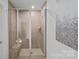 Contemporary tiled shower featuring sleek glass door and convenient built-in seat at 15926 Parkside Crossing Dr # 322, Charlotte, NC 28273