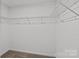 Spacious walk-in closet with ample shelving and rod space for storage at 15926 Parkside Crossing Dr # 322, Charlotte, NC 28273