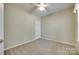 Cozy bedroom with neutral walls, carpet flooring, a ceiling fan, and a white door at 1678 Onyx Rdg, Fort Mill, SC 29708