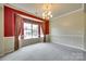 Dining room with large window, neutral paint, plush carpet and elegant chandelier at 1678 Onyx Rdg, Fort Mill, SC 29708