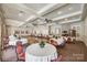 Large event space with hardwood floors, elegant lighting, and ample seating arrangement for various events at 1678 Onyx Rdg, Fort Mill, SC 29708