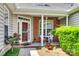 Inviting front porch with seating, brick accents, and mature landscaping at 1678 Onyx Rdg, Fort Mill, SC 29708