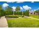 Serene community garden with manicured hedges, lush lawn, and benches for residents to relax at 1678 Onyx Rdg, Fort Mill, SC 29708