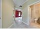 Hallway with tile flooring, leading to a living room and a half-bathroom at 1678 Onyx Rdg, Fort Mill, SC 29708