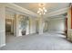 Spacious living room featuring neutral paint, chandelier, and carpet floors at 1678 Onyx Rdg, Fort Mill, SC 29708