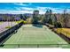 Well-maintained community tennis court surrounded by fencing and trees for residents' active lifestyle at 1678 Onyx Rdg, Fort Mill, SC 29708