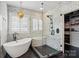 Luxurious bathroom features a freestanding tub, frameless glass shower, and stylish black and white tiles at 201 Mills Ln, Fort Mill, SC 29708