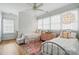 Cozy bedroom featuring twin beds, pink accents, decorative lighting, and wood flooring at 201 Mills Ln, Fort Mill, SC 29708