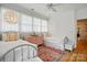 Bright bedroom featuring twin beds, pink accents, decorative lighting, and wood flooring at 201 Mills Ln, Fort Mill, SC 29708