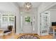 Bright foyer with hardwood floors, a modern light fixture, and a front door with sidelights at 201 Mills Ln, Fort Mill, SC 29708