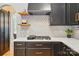 Close-up of the kitchen area with a gas cooktop and decorative backsplash at 201 Mills Ln, Fort Mill, SC 29708