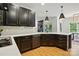 Kitchen with stylish black cabinetry, gold hardware, white countertops and stainless steel appliances at 201 Mills Ln, Fort Mill, SC 29708