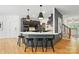 Modern kitchen with black cabinets, white countertops, pendant lighting, and hardwood floors at 201 Mills Ln, Fort Mill, SC 29708