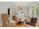 Inviting living room with ample seating, stylish decor, and natural light from shuttered windows at 201 Mills Ln, Fort Mill, SC 29708