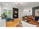 Stylish living room with hardwood floors, fireplace, and plenty of natural light from large windows at 201 Mills Ln, Fort Mill, SC 29708