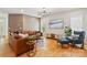 Comfortable living room with leather sofa, hardwood floors, and a large flat screen television at 201 Mills Ln, Fort Mill, SC 29708
