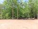 Cleared lot showcases the natural beauty of the surrounding woods, ready for landscaping at 2099 Cedar Rd, York, SC 29745