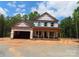 New home featuring an open garage and brick foundation awaits its finishing touches at 2099 Cedar Rd, York, SC 29745
