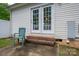 Outdoor space features white siding, brick steps, and double doors, perfect for relaxing or entertaining at 210 Park St, Bessemer City, NC 28016