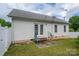 Exterior view of backyard with vinyl siding, patio, and grassy area at 210 Park St, Bessemer City, NC 28016