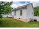 Exterior view of house with vinyl siding, satellite dish, patio and green grass at 210 Park St, Bessemer City, NC 28016