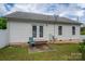 Backyard view with double french doors, small patio and a green chair at 210 Park St, Bessemer City, NC 28016