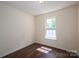 Bedroom with hardwood floors and a sunlit window offering natural light at 210 Park St, Bessemer City, NC 28016