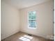Bright bedroom featuring neutral carpet and a window letting in natural light at 210 Park St, Bessemer City, NC 28016