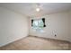 Bedroom featuring carpet, ceiling fan, neutral walls and window with curtains at 210 Park St, Bessemer City, NC 28016