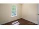 Bedroom view with hardwood flooring, window and neutral painted walls at 210 Park St, Bessemer City, NC 28016