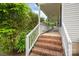 Brick steps lead to the inviting front porch, surrounded by lush landscaping at 210 Park St, Bessemer City, NC 28016