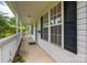 Inviting front porch with white railing, black shutters, and a view of the landscaped yard at 210 Park St, Bessemer City, NC 28016
