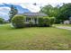 Charming home featuring a covered front porch and a well-maintained lawn and mature landscaping at 210 Park St, Bessemer City, NC 28016