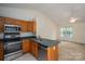 Cozy kitchen features stainless steel appliances, wood cabinets and a breakfast bar at 210 Park St, Bessemer City, NC 28016