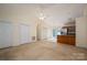 Bright living room with vaulted ceiling, neutral walls, and flows into the kitchen at 210 Park St, Bessemer City, NC 28016