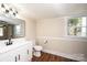 Bathroom features a modern vanity, toilet, and large mirror at 210 W 15Th St, Newton, NC 28658