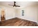 Bright bedroom features stylish ceiling fan, wood floors, and a window with a view to outside at 210 W 15Th St, Newton, NC 28658