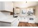 Modern white kitchen featuring stainless appliances, quartz countertops and hardwood floors at 210 W 15Th St, Newton, NC 28658