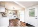 Bright kitchen with white cabinets, stainless appliances, and a view of the backyard at 210 W 15Th St, Newton, NC 28658